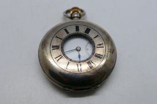 A Victorian silver half hunter pocket watch with Roman numerals to a white enamel dial,