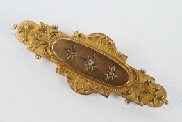 A 9 carat gold bar brooch set with three small stones, approx weight 3.