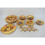 A collection of fruit decorated table wares by Claytondale, in excess of 70 pieces. [3]. [W].