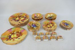 A collection of fruit decorated table wares by Claytondale, in excess of 70 pieces. [3]. [W].