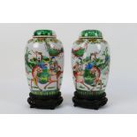 A pair of Chinese covered vases decorated with a warrior and scholar on horseback,