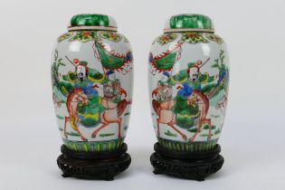 A pair of Chinese covered vases decorated with a warrior and scholar on horseback,