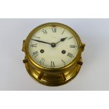 A brass ships clock or bulkhead clock,