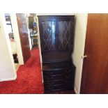 A carved oak bookcase with glazed front doors,