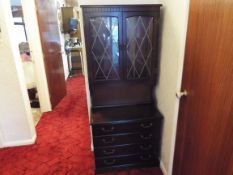 A carved oak bookcase with glazed front doors,