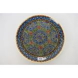 A Middle Eastern earthenware charger with hand painted decoration, 32 cm (d).