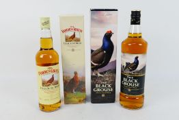 A 1l bottle of Black Grouse and a 70cl bottle of Famous Grouse,