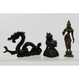 A group of small Asian cast metal figures to include a dragon, Indian deity and similar, largest 10.