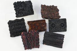 A collection of vintage, carved wooden printing blocks.