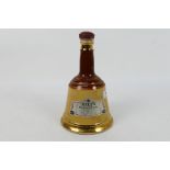 A Wade Bells 26⅔ floz decanter of whisky, 70° proof.