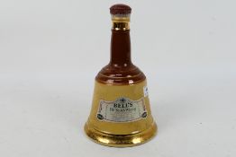 A Wade Bells 26⅔ floz decanter of whisky, 70° proof.