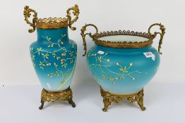 A blue glass jardiniere with gilt metal mounts and hand painted foliate decoration,