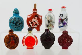 A group of snuff bottles to include glass, ceramic and similar.