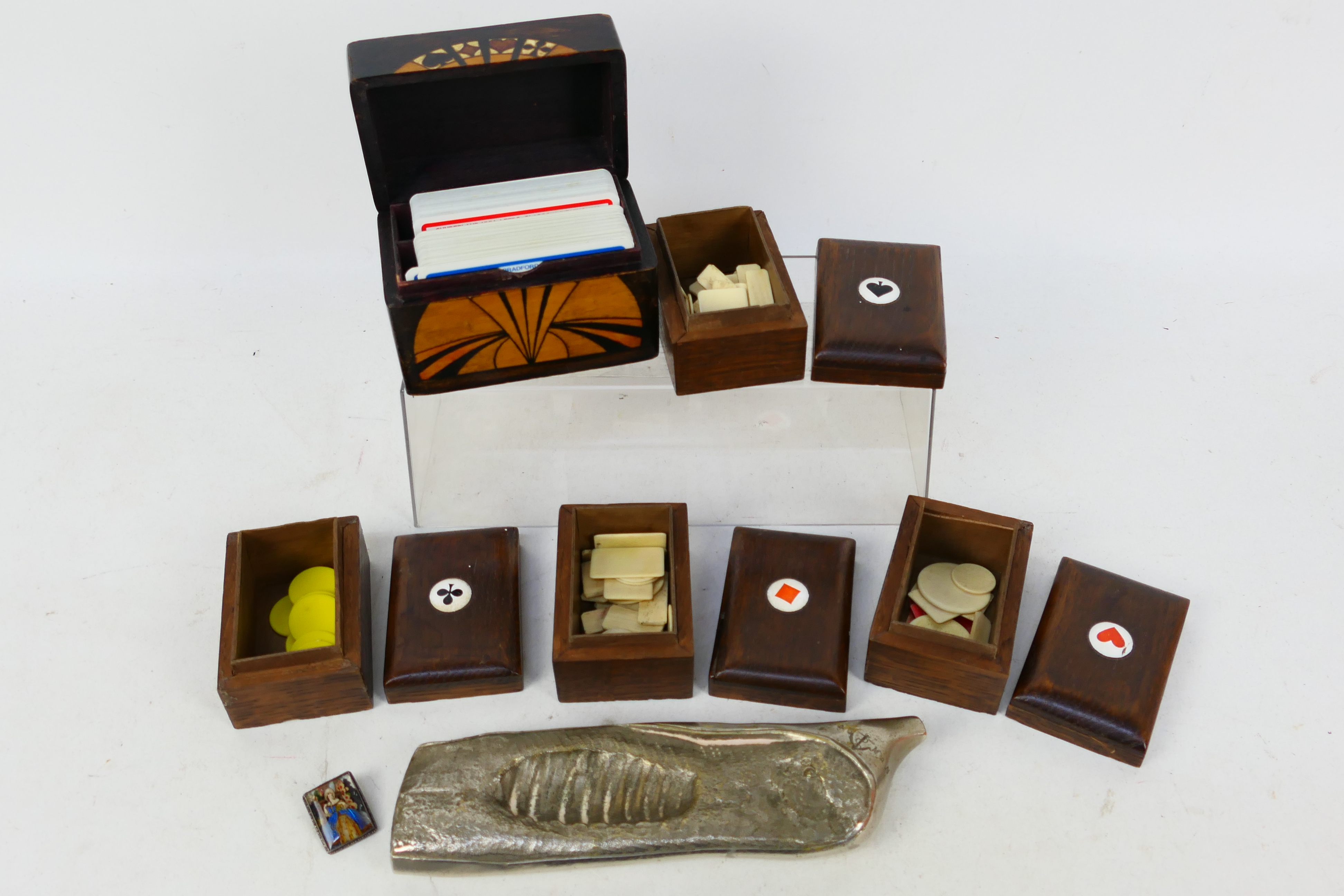 A wooden card box, gaming token boxes with a small quantity of bone and plastic tokens,