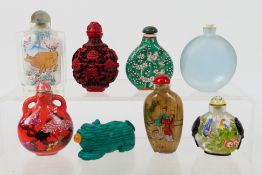 A collection of snuff bottles to include glass, ceramic and other.