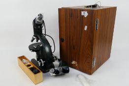 A Vickers Instruments M70 binocular microscope contained in fitted case with accessories.