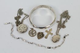 A collection of silver and white metal jewellery to include bangle, lockets, pendants and other.