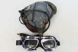 An RAF G Type canvas flying helmet with earphones and goggles.