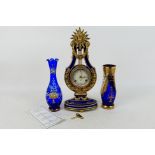 A Franklin Mint porcelain cased Marie-Antoinette Clock, cobalt blue and gilt of lyre form,