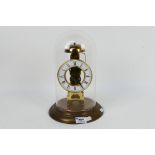 A President skeleton clock with Roman numeral chapter ring, housed under glass dome, 29 cm (h).