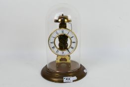 A President skeleton clock with Roman numeral chapter ring, housed under glass dome, 29 cm (h).