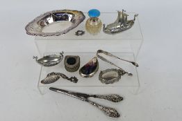 A mixed group of small items to include hallmarked silver dish, silver handled glove stretchers,
