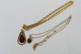 A 9ct yellow gold pendant set with garnet with 9ct gold snapped fine belcher chain,