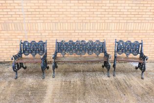 A Victorian cast iron and wood garden suite comprising two single seat armchairs and a twin seat