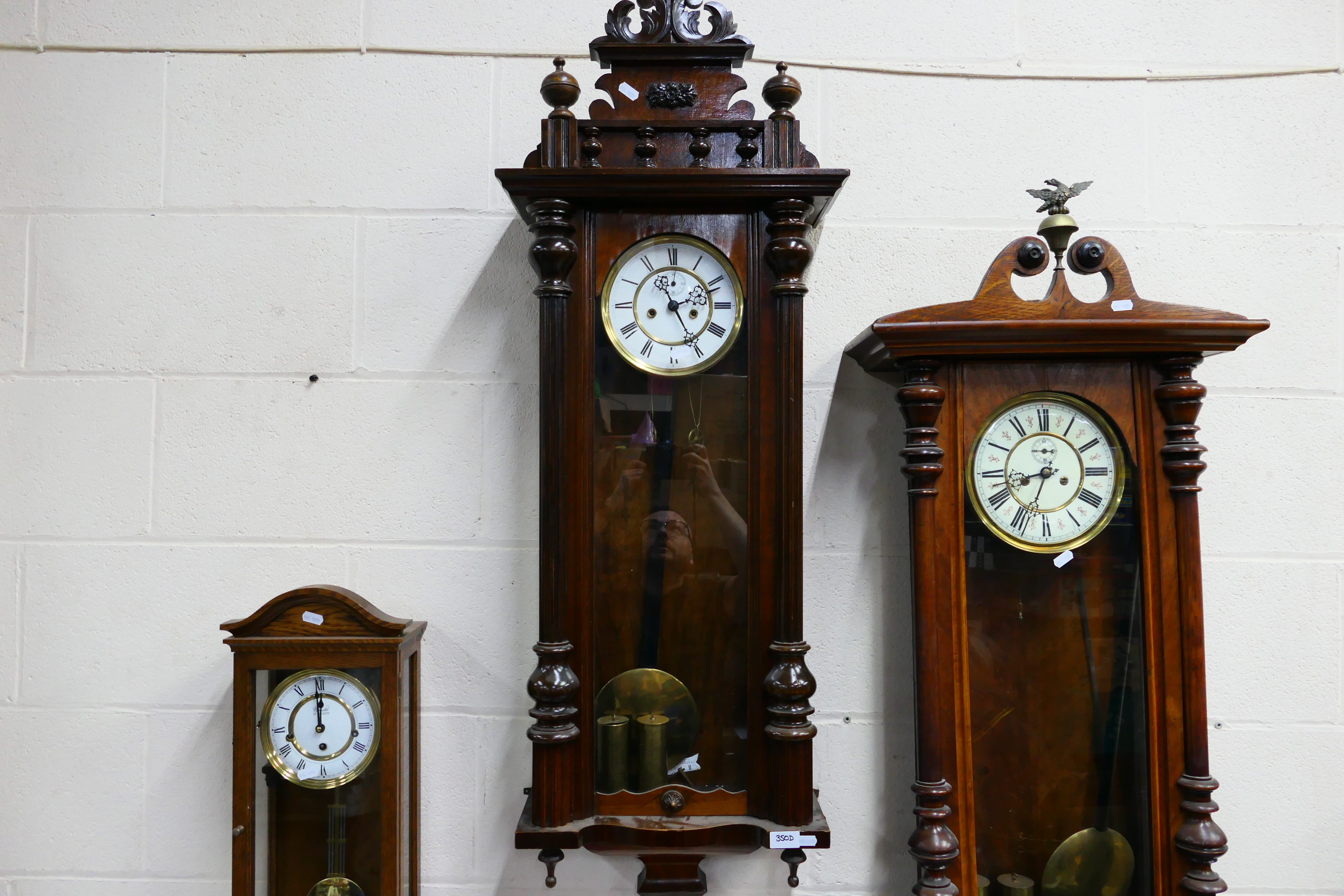 A Vienna style wall clock, walnut case with opening, glazed door, flanked by turned reeded columns,