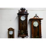 A Vienna style wall clock, walnut case with opening, glazed door, flanked by turned reeded columns,