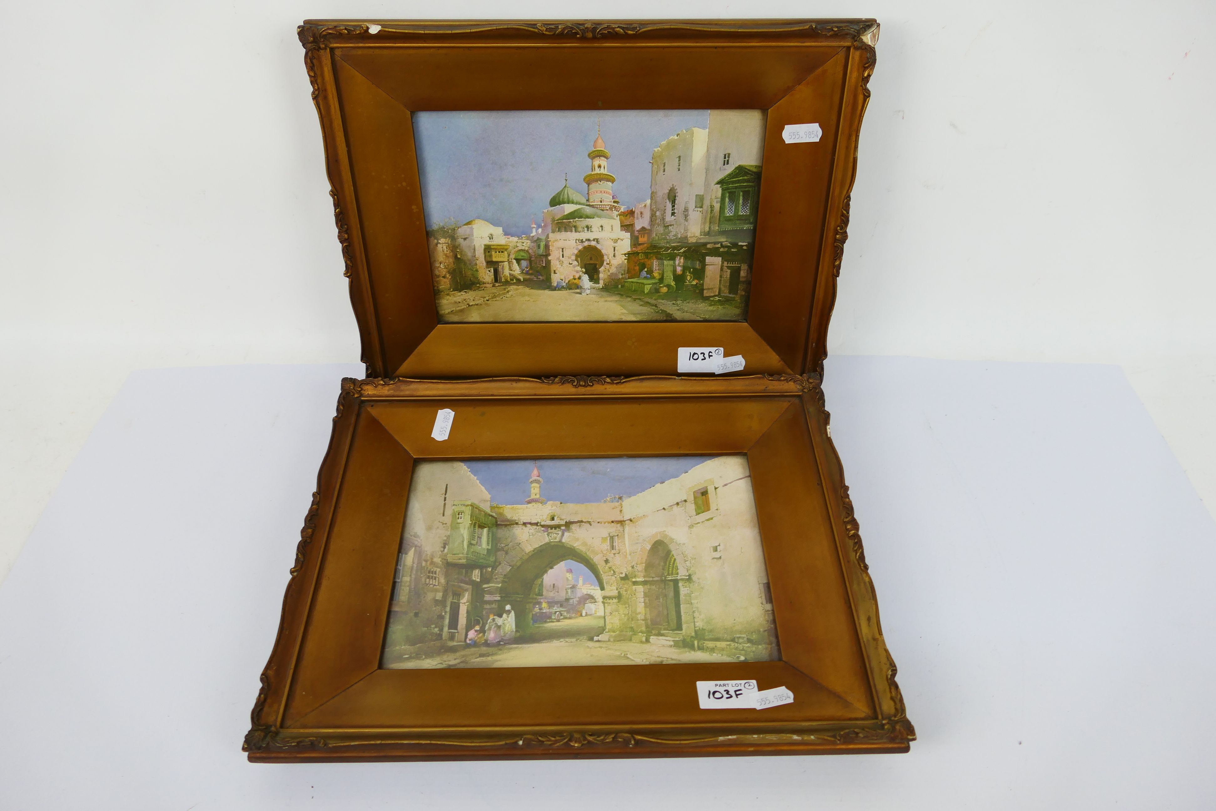 A pair of vintage prints depicting middle eastern scenes, framed under glass,