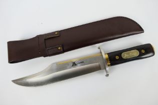 A large Bowie type knife, a replica of John Wayne's knife from The Alamo,