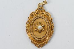 A 9ct yellow gold Victorian style locket set with a cultured pearl to the centre, approx weight 5.