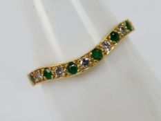 A hallmarked 18ct yellow gold wishbone ring set with five round emeralds and five round brilliant