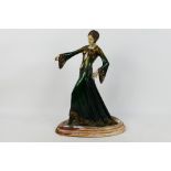A cold cast Art Deco style figure depicting a stylish young lady, raised on marble base,