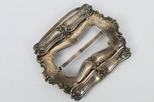 A nurse's silver belt buckle,