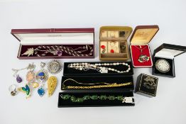 A group of costume jewellery to include brooches, necklace, bracelets and other,
