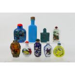 A collection of snuff bottles to include glass, ceramic and other.