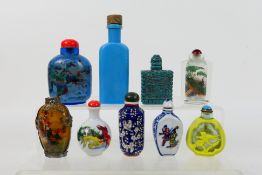 A collection of snuff bottles to include glass, ceramic and other.