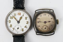 Two silver cased trench style watches.