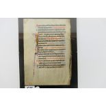 An illuminated manuscript page of Latin text, 20 lines, framed, page approximately 24 cm x 17 cm.