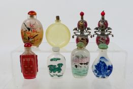 A group of snuff bottles to include glass, ceramic and other.