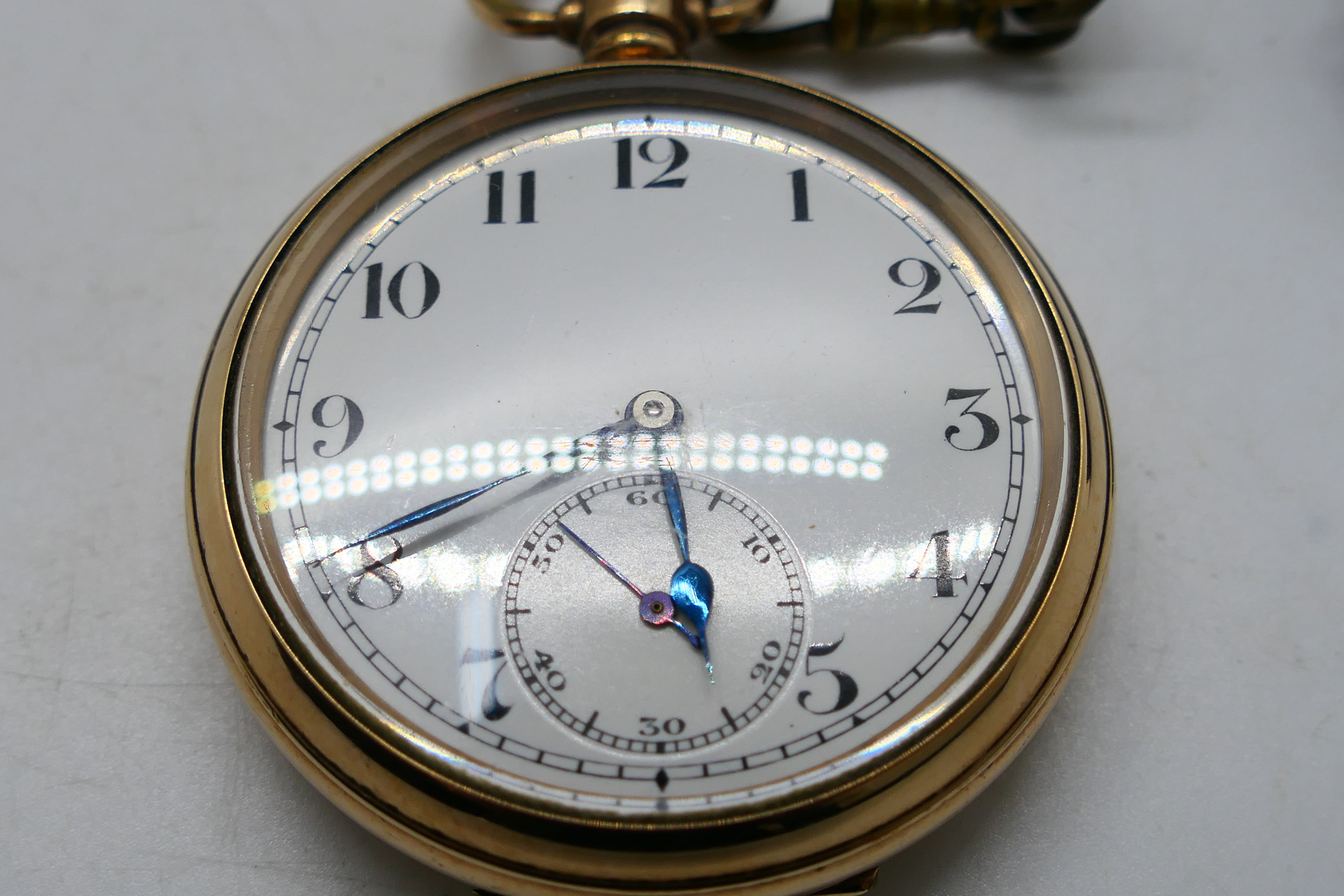 A gold plated open face pocket watch, Arabic numerals to a white enamel dial, - Image 2 of 8