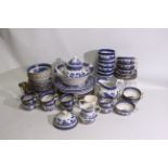 A quantity of blue and white table wares, Booths Real Old Willow and a Churchill teapot,