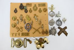 A collection of cap badges and similar to include Royal Electrical and Mechanical Engineers,