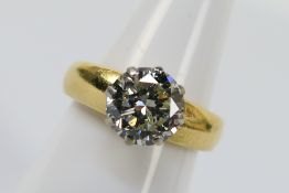 An 18ct yellow gold solitaire Diamond ring comprising one round brilliant cut Diamond set in a