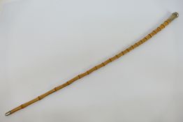 A white metal mounted Gordon Highlanders swagger stick, approximately 74 cm (h).