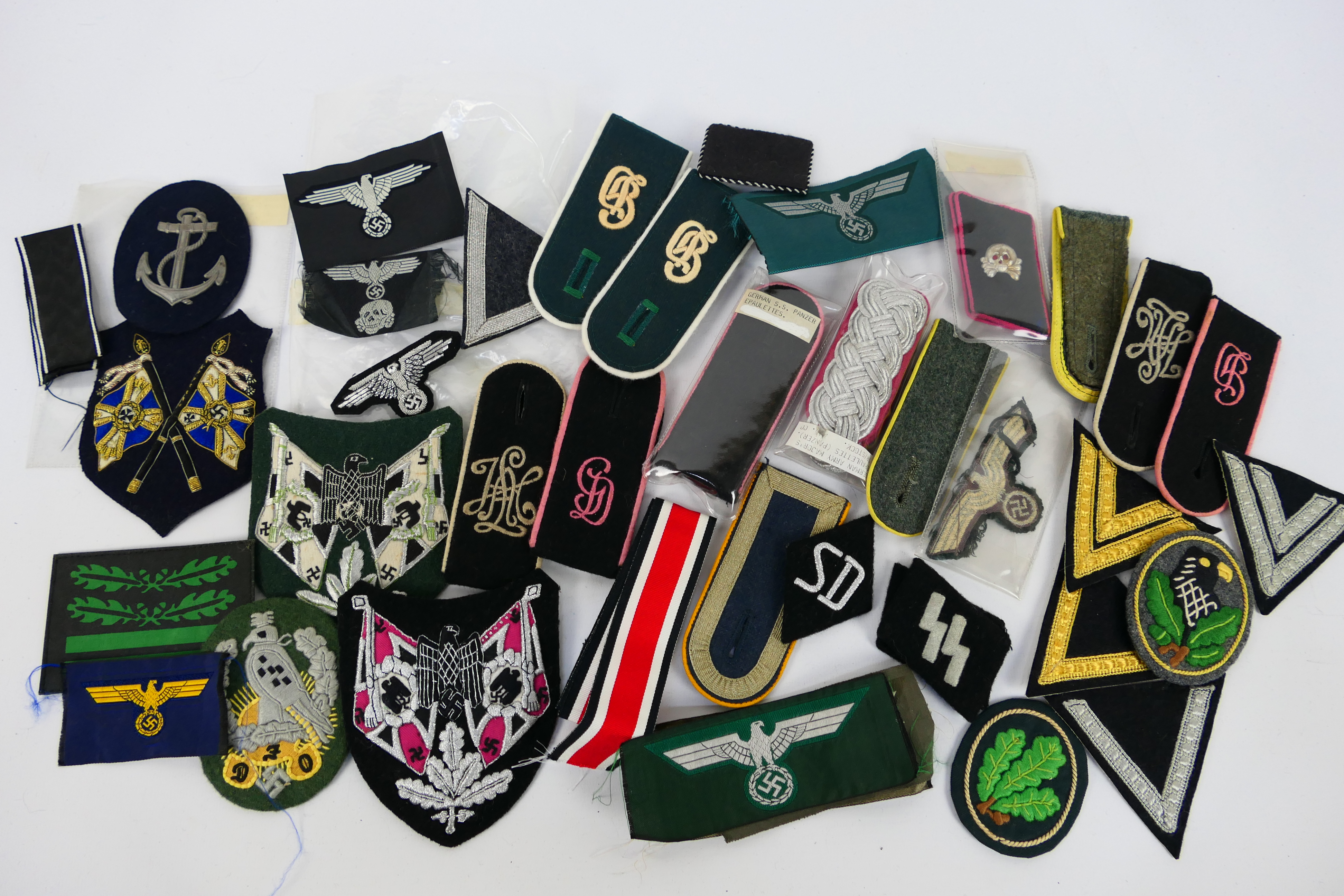 A collection of World War Two (WW2 / WWII) style German insignia to include collar tabs,