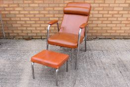 A brown leather chair with matching foot
