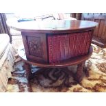 A circular oak coffee table incorporatin